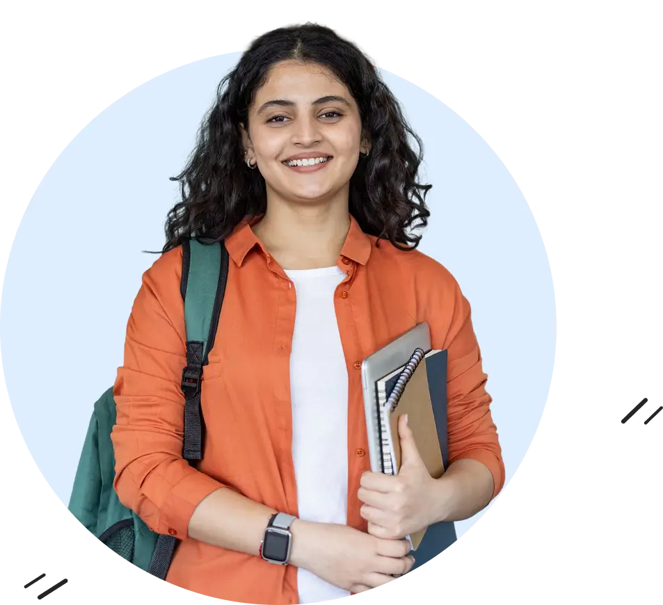 A smiling female college student with curly hair, wearing an orange shirt and backpack, holding books and a laptop